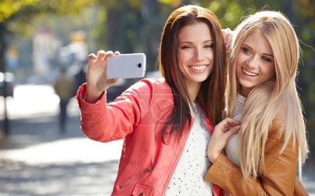 Beautiful young women making selfie