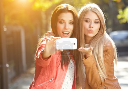 Beautiful young women making selfie