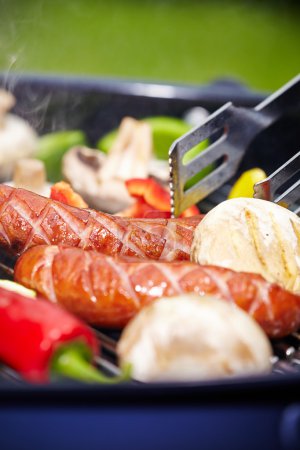 Grilling Sausages on barbecue grill