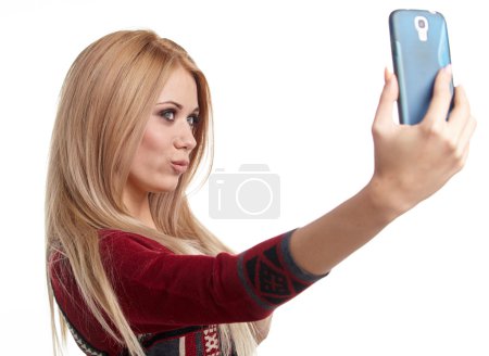 Beautiful blonde girl taking selfie
