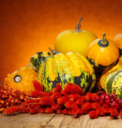 Decorative pumpkins on old wooden table