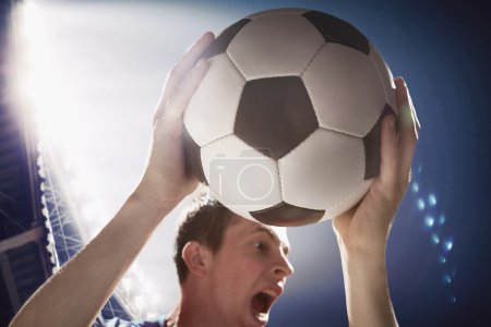 Athlete with soccer ball in her hands