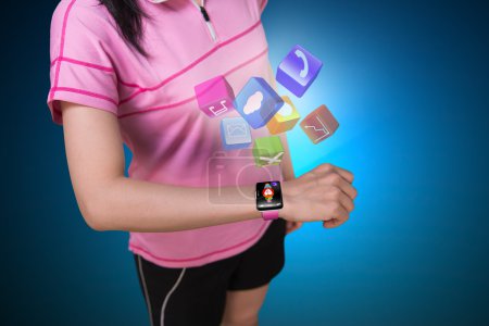Sport woman wearing touchscreen smartwatch with colorful app ico