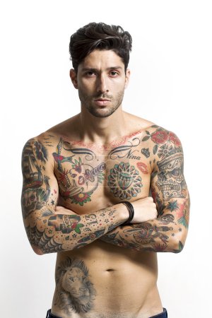 Handsome tattooed man portrait with crossed arms