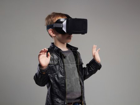 little Boy in virtual reality glasses playing the game. 3D VR glasses cardboard