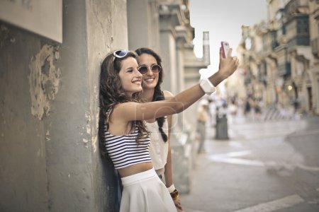To friends taking a picture of themselves