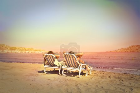 Two young girls relaxing at the beach