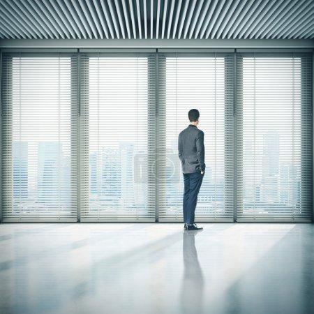 Businessman  in office and looking at megalopolis