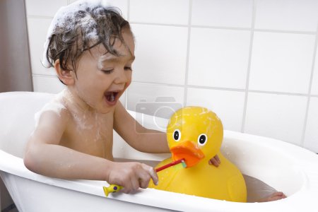 cute toddler playing in a bathtub