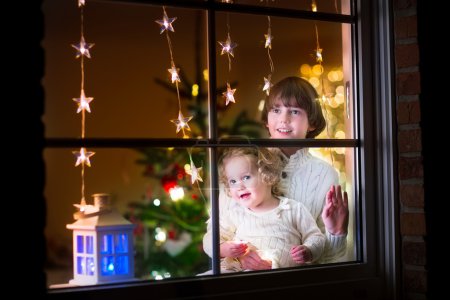 Kids at window on Christmas eve