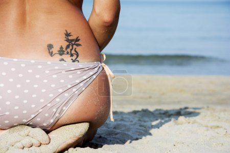 Good looking woman on beach sitting