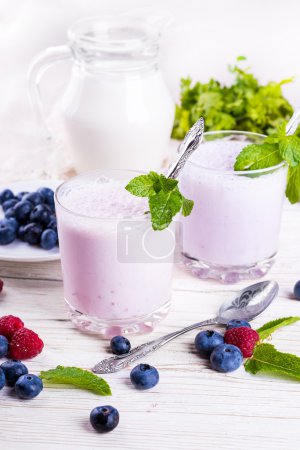 Milkshake with blueberries, raspberries and mint