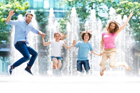 Happy young family jumping