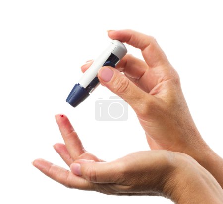 glucometer's  stick  in woman hand  