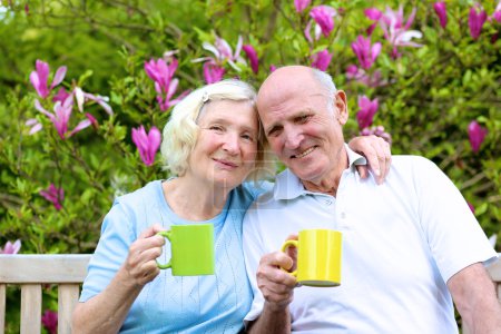 Senior couple drinking tea in the garden