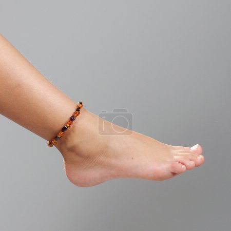 Girl foot isolated on the grey background