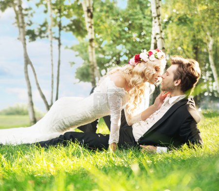 Marriage couple lying on the lawn