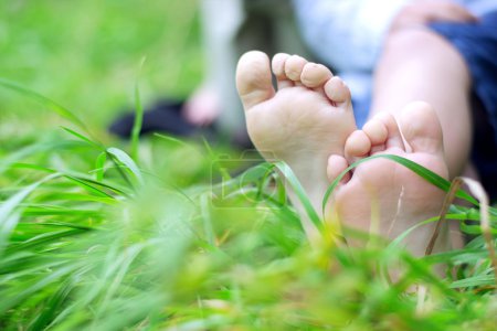 Little boy's feet on grass