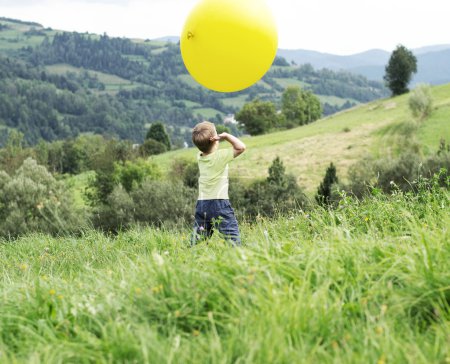 Small boy playing a huge balloon