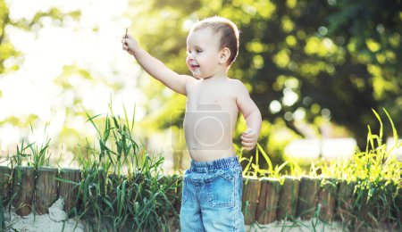Small boy playing in the garden