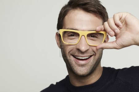 Man in yellow glasses smiling