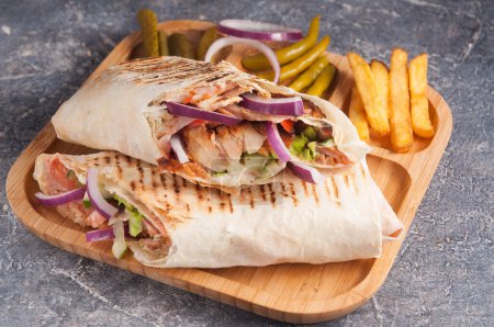 tasty Turkish Shawarma with chicken and vegetables with onions