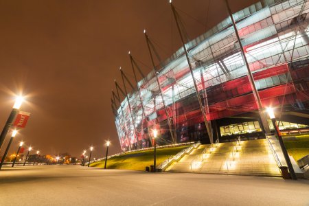 National Stadium in Warsaw illuminated at night by national colors, Poland