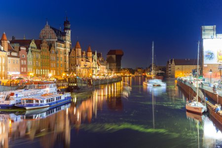 Old town of Gdansk at night with reflection in Motlawa river