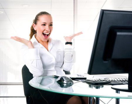 Happy businesswoman sits at the computer