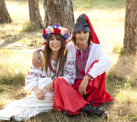 Slav girl with wreath and young cossack at nature