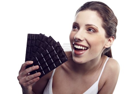 Studio portrait of a young woman with a brick of chocolate isola