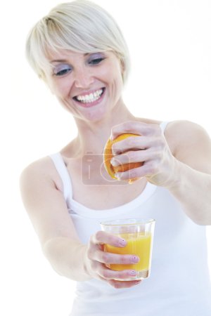 Young woman squeeze orange juice