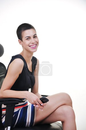 Brunette female model posing on business chair