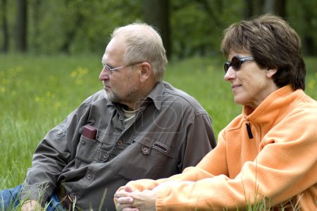 Senior couple in a green grassfield