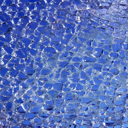 Broken glass cracked over blue background