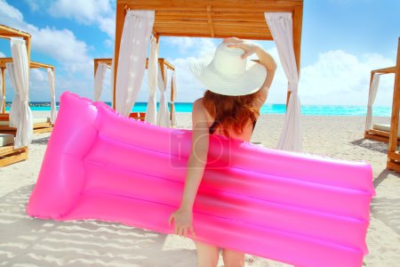 Floating lounge pink girl in caribbean tropical beach