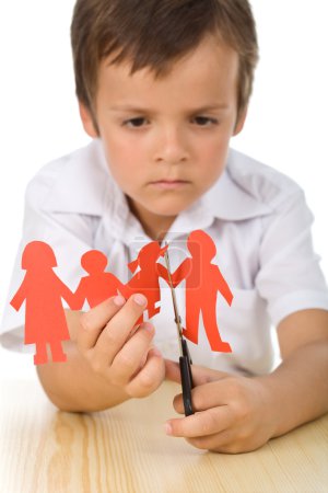 Sad boy cutting paper family - divorce concept