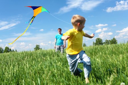 Father with son in summer with kite