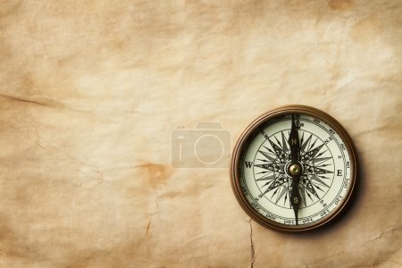 Vintage compass on old paper with copy space
