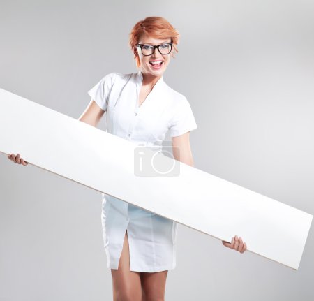 Smiling woman holding white board