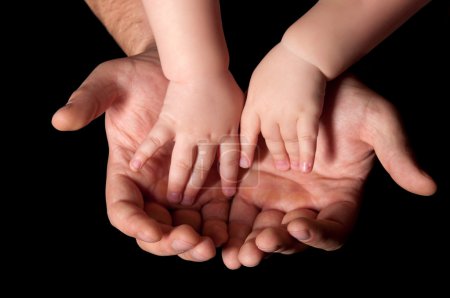 The hands of father and child