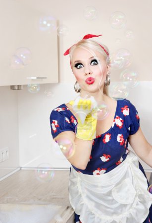 Housewife playing with soap bubbles