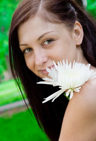 Beautiful smiling woman with a flower
