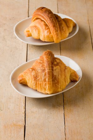 Croissants on wooden table