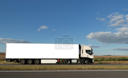 Long white truck on highway