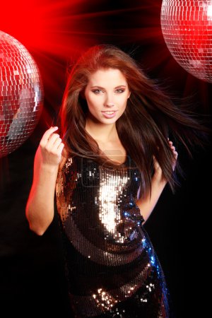 Girl dancing over mirror ball background