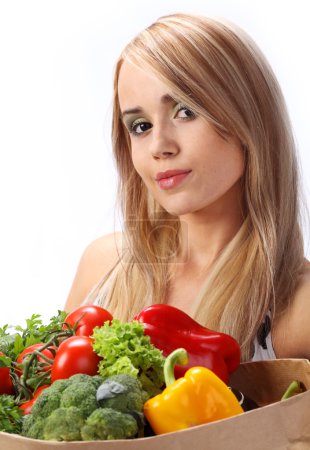 Woman holding fresh vegetables