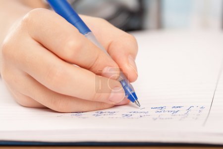 Anonymous pupil hand writing homework