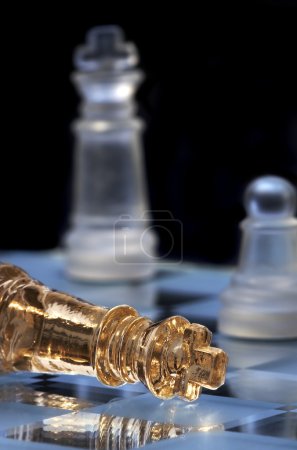Chess king lays on a chessboard. A victo