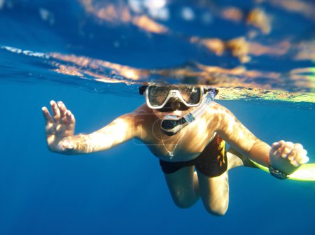 Boy floats under water